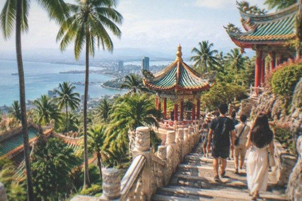 Visitors climbing the steps of a hillside temple above Cebu City on a guided day