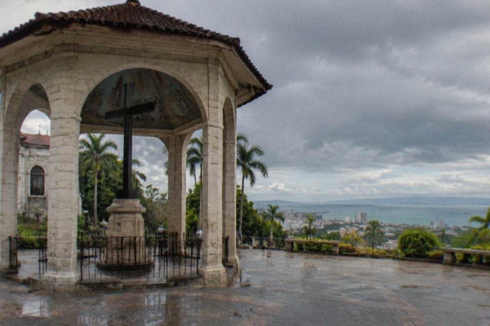 Rain clouds passing over the Cebu City skyline with the sea and upland areas visible beyond