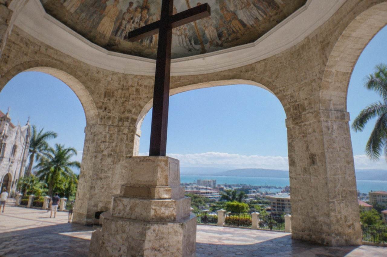 A view over Cebu City buildings toward the Mactan Channel with hills in the background