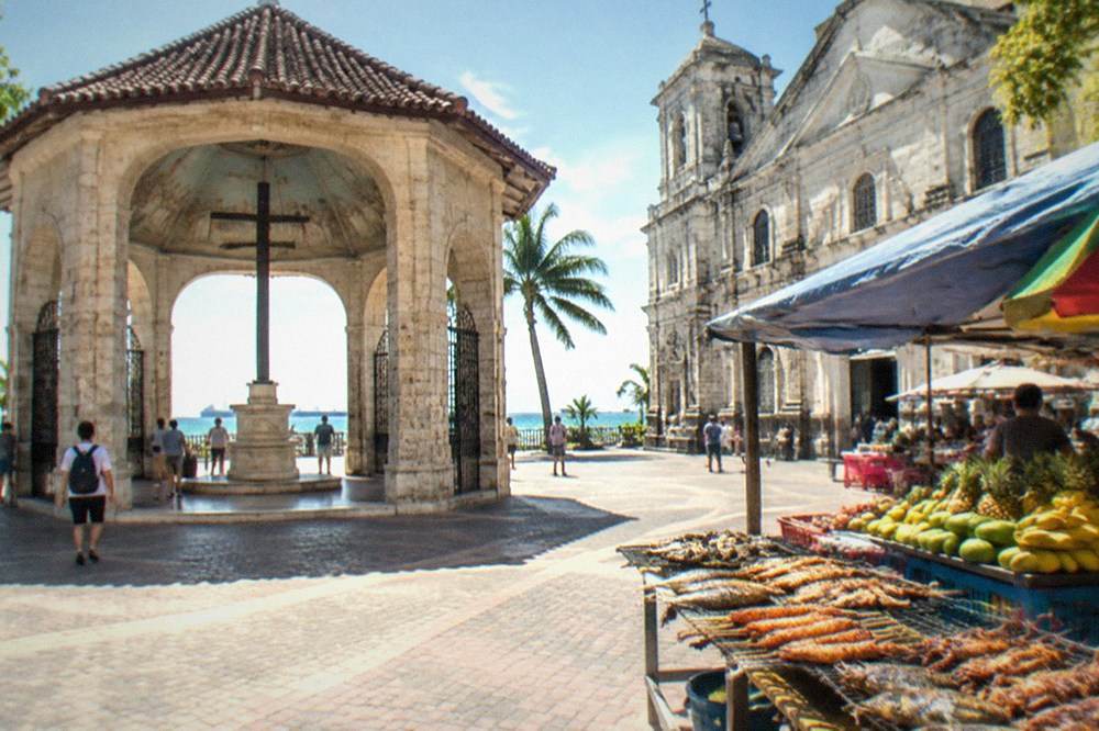 A food market stall in Cebu City displaying grilled seafood and tropical fruit