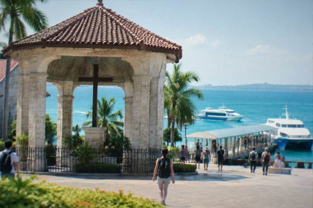 A ferry terminal pier in Cebu with fastcraft boats moored and passengers boarding