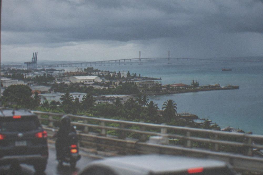Rain clouds gathering over the Mactan Channel with bridge traffic lights blurred in the foreground