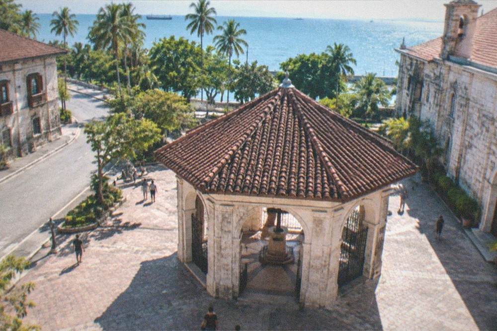 A quiet heritage street in Cebu City with an old stone house at the corner