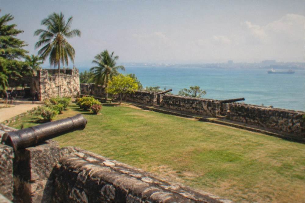 Ancient coral-stone fort walls of Fort San Pedro in Cebu City with green lawn