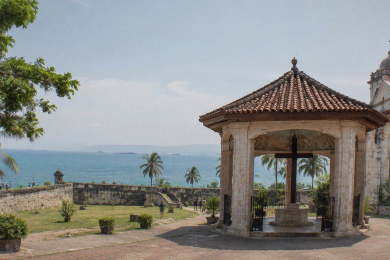 Stone walls and a grassy courtyard inside a triangular Spanish colonial fort in Cebu City