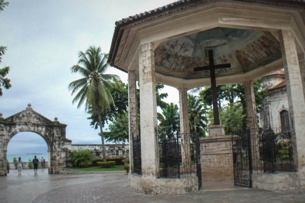 A low stone archway entrance leading into the courtyard of a Spanish fort in Cebu
