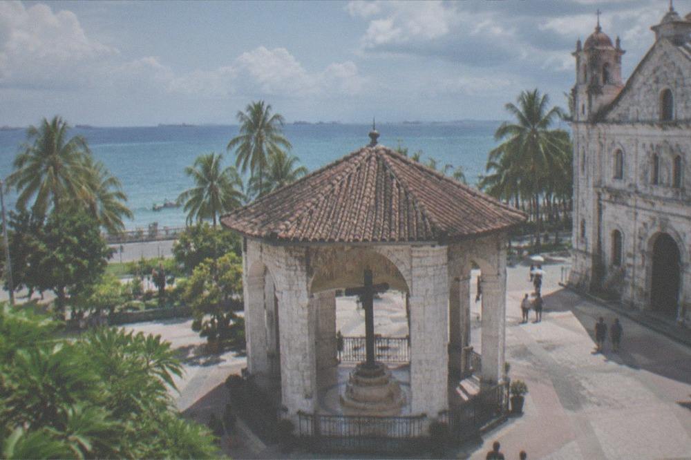 A historical marker and weathered coral stone wall at a Spanish colonial fort in Cebu