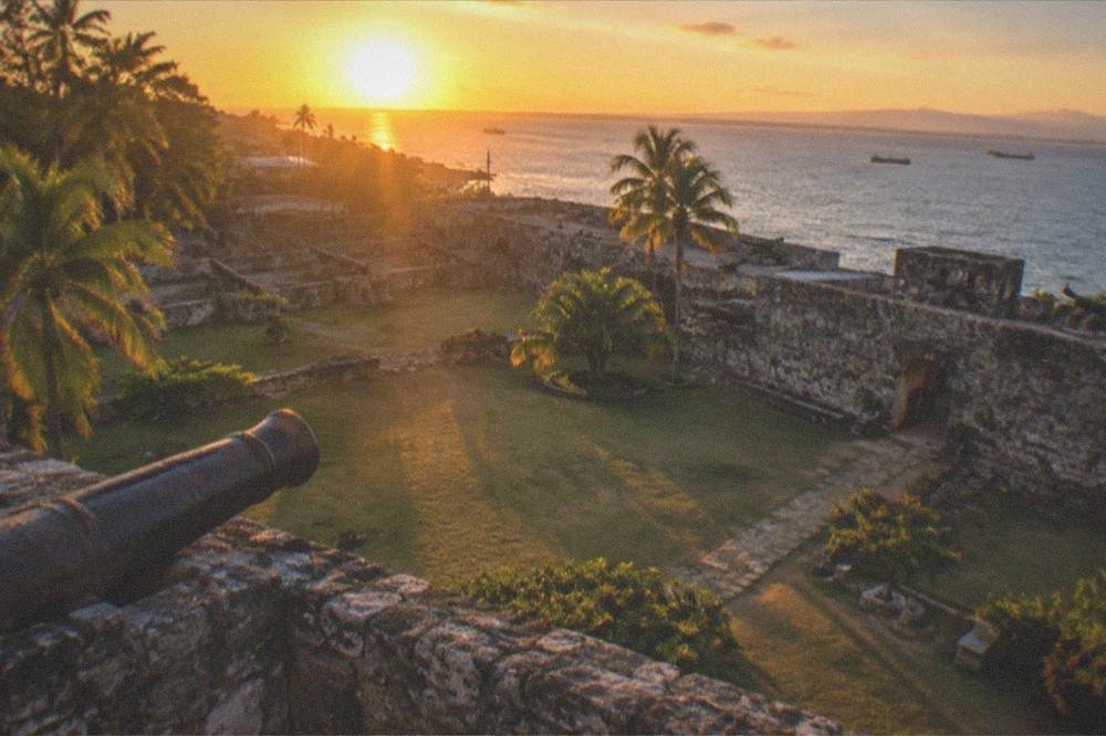 The sun setting behind the stone bastions of Fort San Pedro in Cebu City