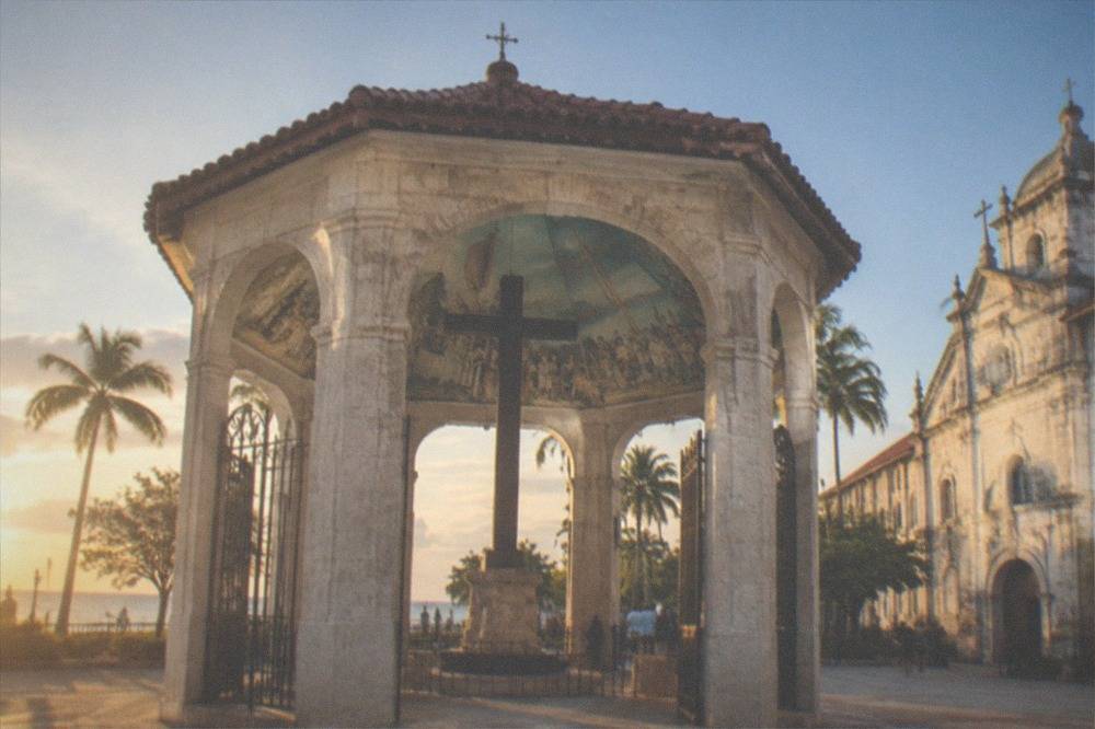 The painted ceiling inside the Magellan's Cross pavilion, with panels depicting the planting of the cross and early baptisms