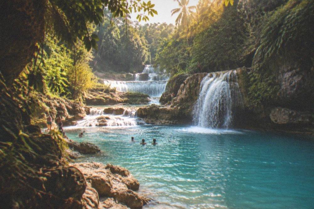 Turquoise pools and cascades at Kawasan Falls in Badian, surrounded by jungle, a popular day tour pairing from Cebu City