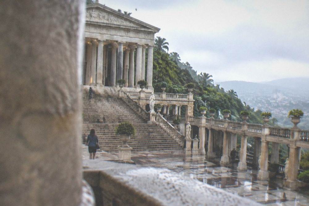 A wide exterior staircase leading up to a columned temple facade in afternoon light