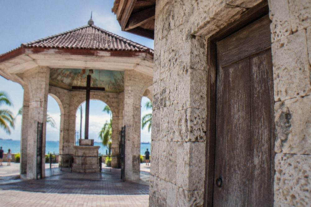 A close view of coral-stone walls and a weathered wooden door on a colonial-era house in Cebu City