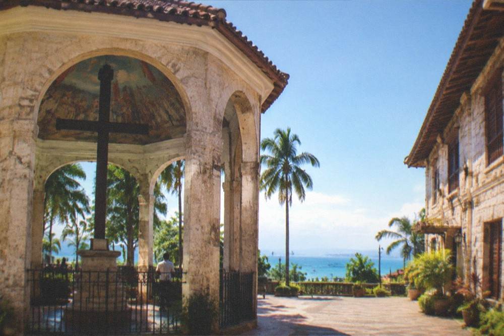 A heritage house in Cebu City's Parian district at golden hour, with warm light on coral stone walls