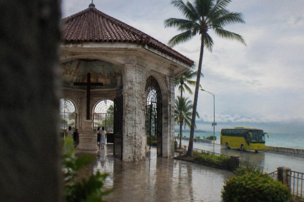 A Ceres bus on the coastal highway south of Cebu City with the sea on the left