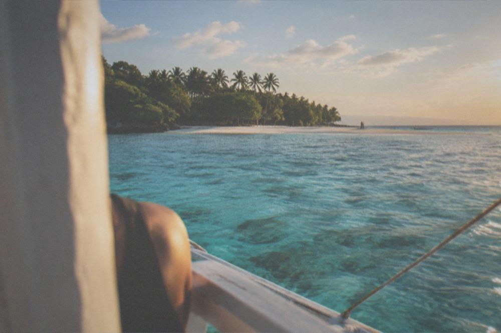 A white sandbar and turquoise lagoon on Sumilon Island seen from a small boat