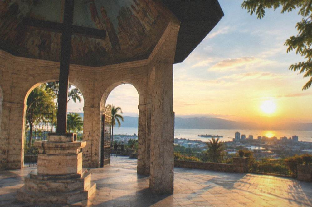 A view over Cebu City at sunset with the sea and hills in the background