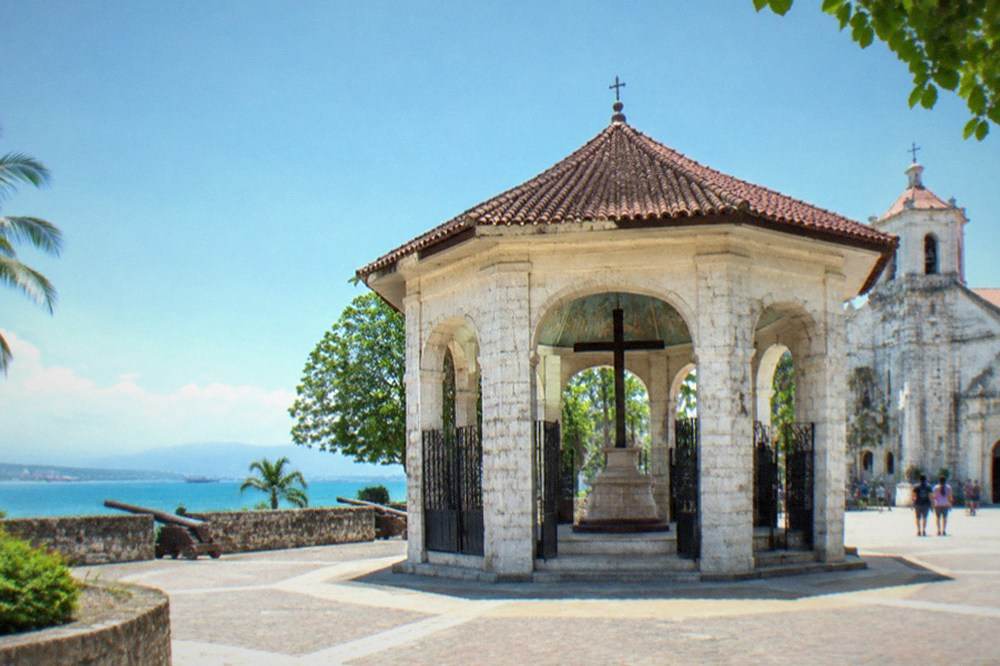 A stone fort courtyard in Cebu City with low walls and shaded walkways