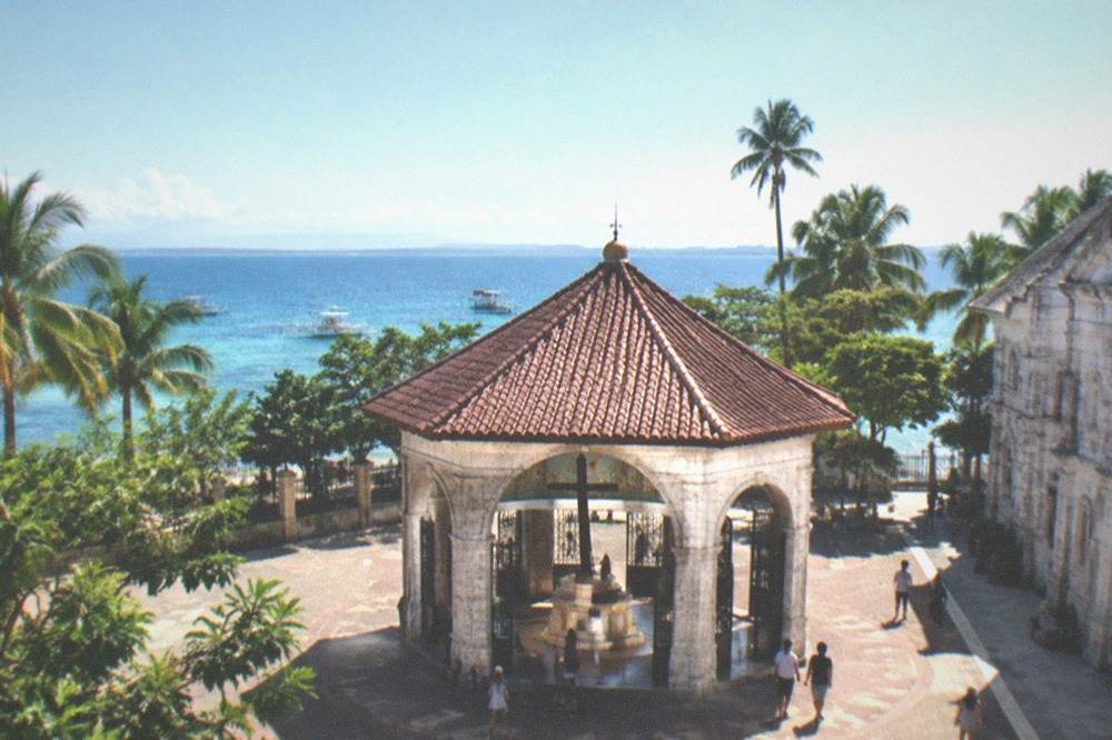 A calm beach morning with clear water and a bright sky on a Cebu island in the dry season