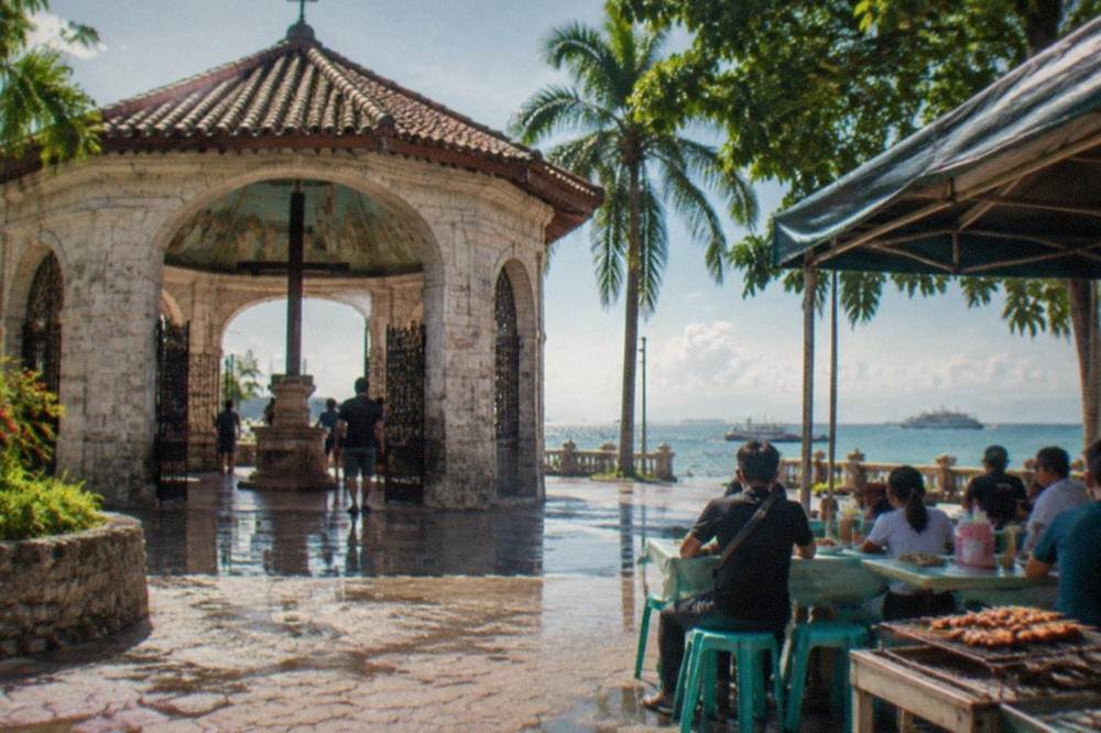 A local eatery in Cebu serving rice and grilled dishes to customers on plastic stools