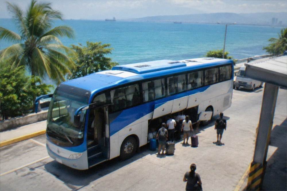 A bus parked at the Cebu South Bus Terminal with passengers loading bags