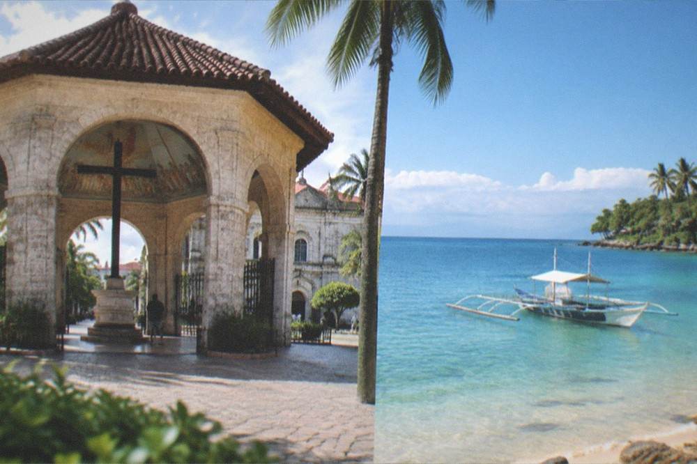 A wooden outrigger boat anchored in shallow turquoise water near a Cebu beach