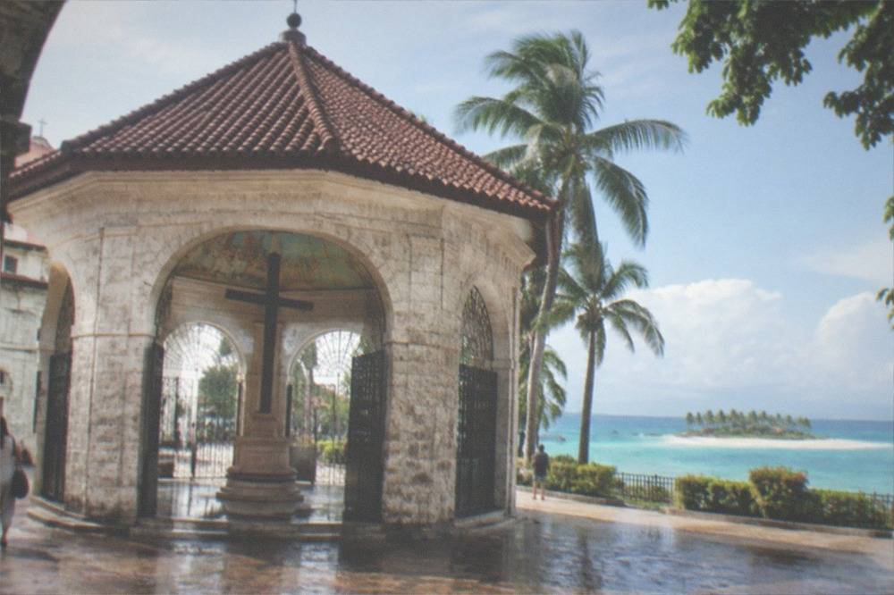 Turquoise lagoon with a sandbar and palm trees on a small tropical island