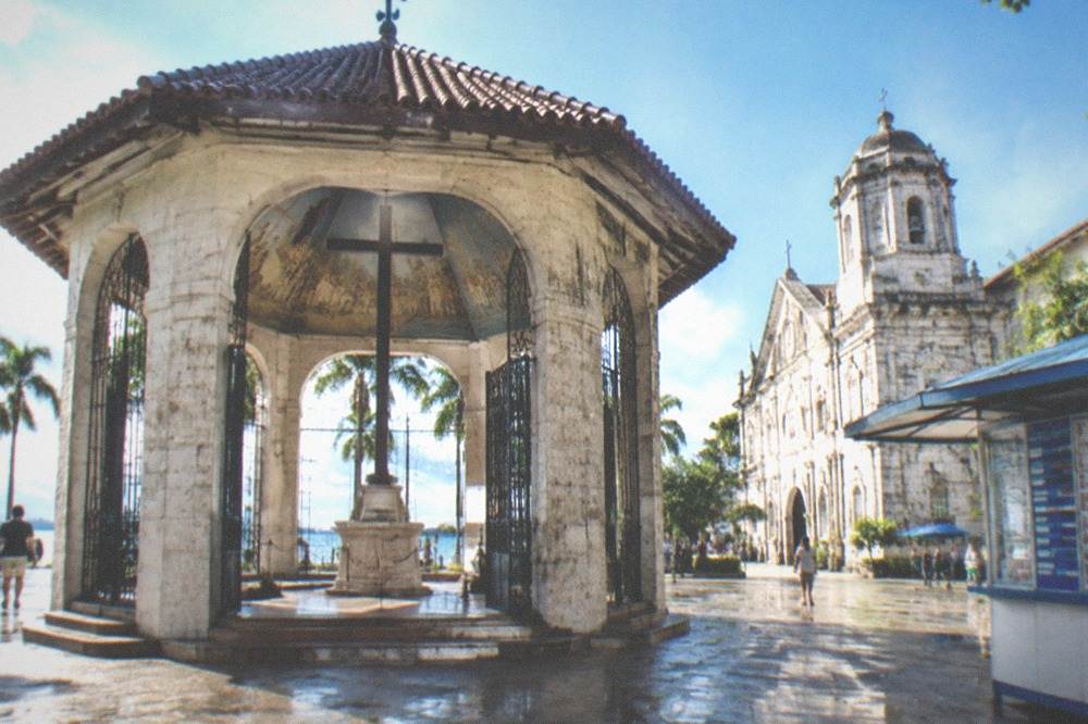 A money changer booth displaying exchange rate boards for dollars and pesos