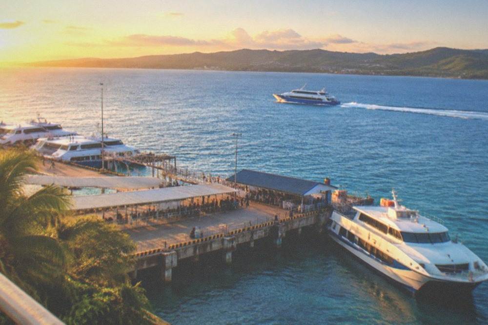 A fastcraft ferry cutting across open blue water between Cebu and Bohol