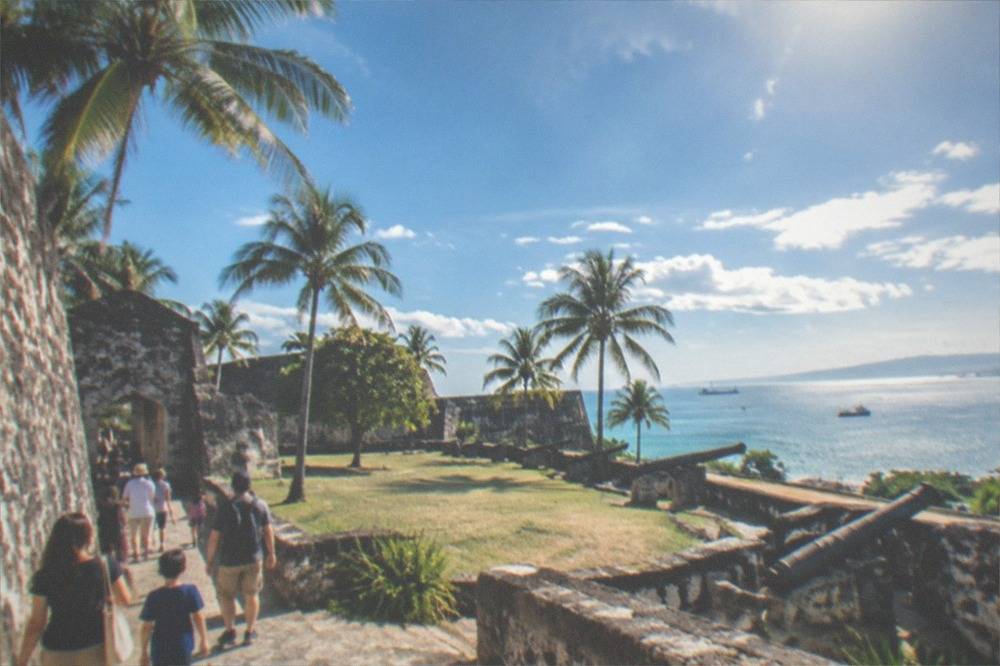 Families and visitors walking through the stone walls of Fort San Pedro in Cebu City