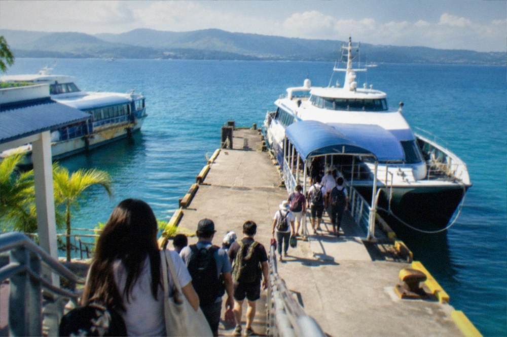 Passengers boarding a fastcraft ferry at a Cebu City pier for the crossing to Bohol