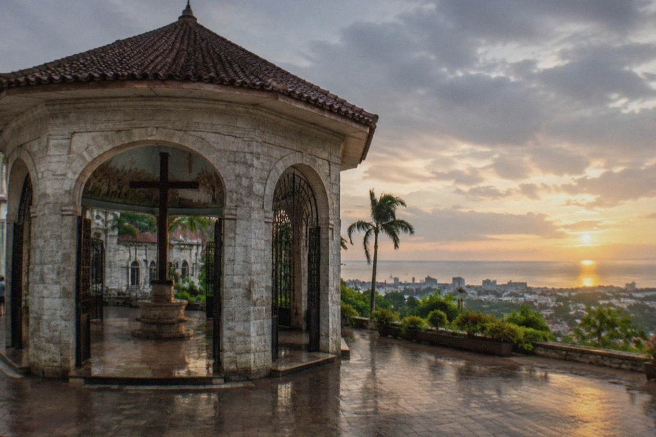 A panoramic view over Cebu City's rooftops and the sea beyond at golden hour