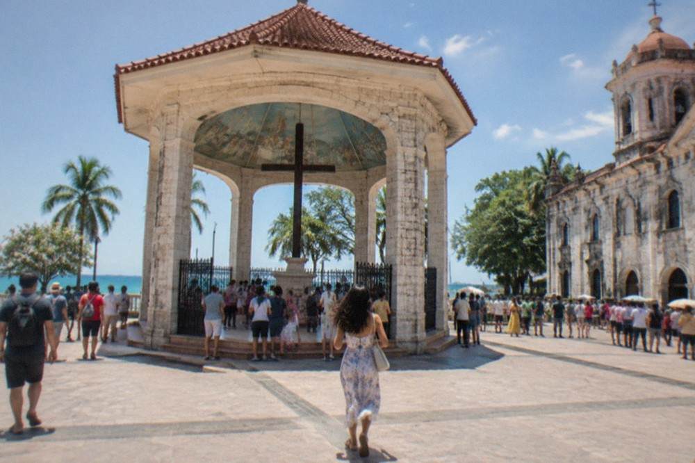 Crowds gathered outside a historic stone church in downtown Cebu City during a festival day