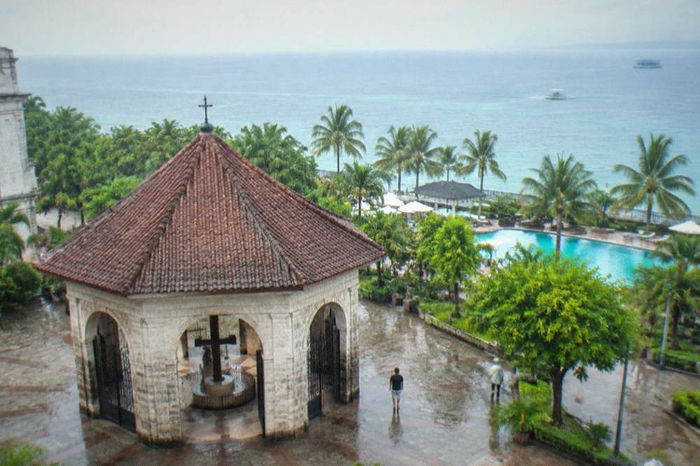 Resort swimming pool and palm trees on the Mactan coastline