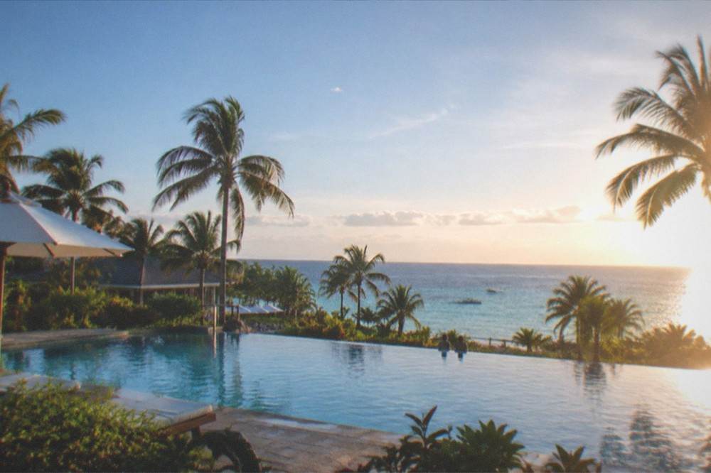 A resort pool and palm trees overlooking the sea on Mactan Island, Cebu