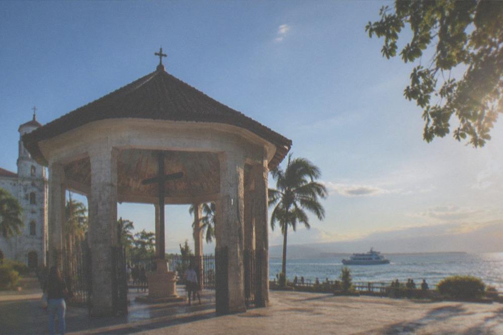 A passenger ferry crossing clear water between Cebu and nearby islands